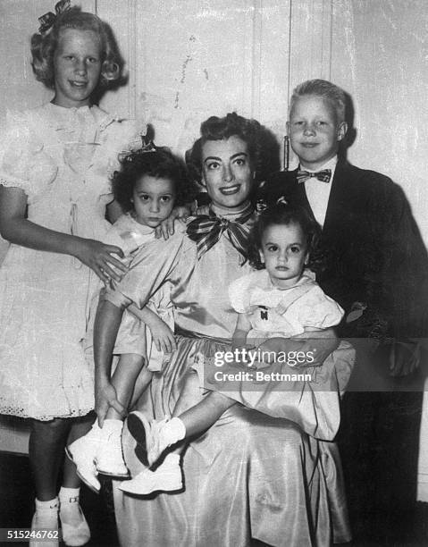 Hollywood, CA- Screen star,Joan Crawford, gathers her children, Christine, Cathy, Cindy and Christopher, around her for a rare family portrait. At...