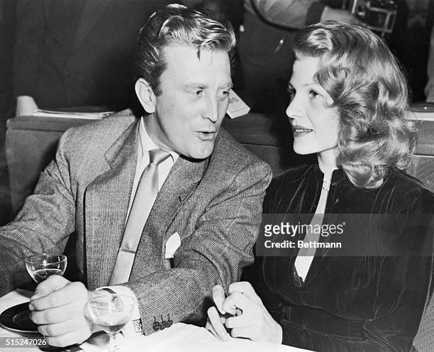 Lovely screen actress Rita Hayworth, reported to be planning a trip to Reno to complete her divorce from Aly Khan, sits with actor Kirk Douglas at a...