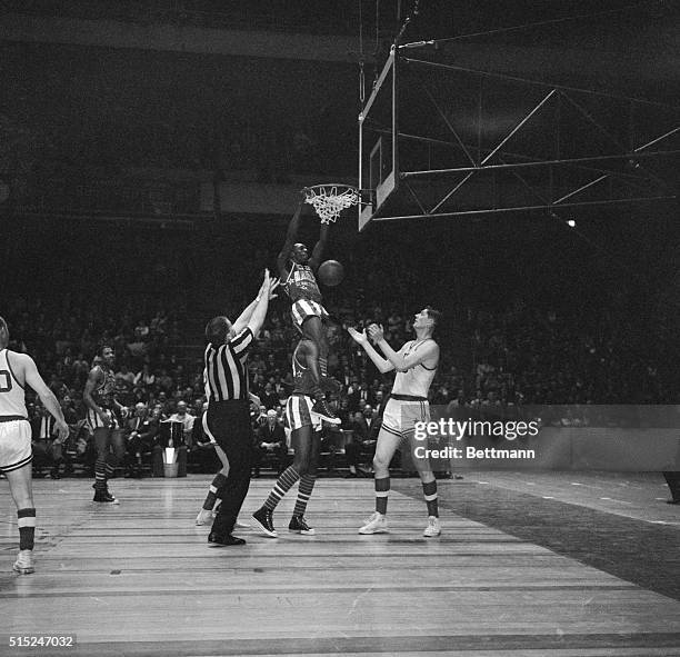 Globetrotters-Baltimore basketball game. Madison Square Garden. Meadowlark Lemon of Globetrotters sits on shoulders of Joe Buckhalter and makes...