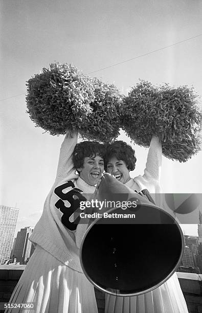 Gotham Bowl game cheerleaders Diane Dornbos and Nan Richards going through cheers atop the Hotel Manhattan in New York City.