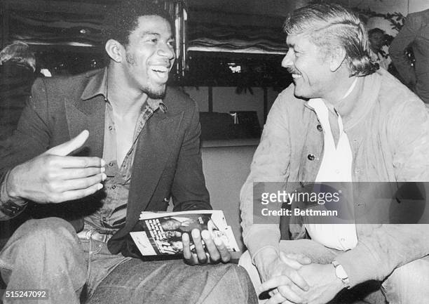 Earvin "Magic" Johnson and Jerry Buss owner of the Los Angeles Lakers basketball team, laugh at jokes they make to each other as they wait in the...