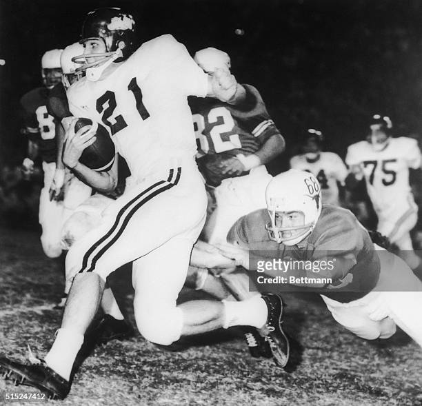 Jim Lindsey Arkansas back gallops for 8-yards before Texas' Barney Giles made a dive to trip him up in the first period of the Texas-Arkansas game.