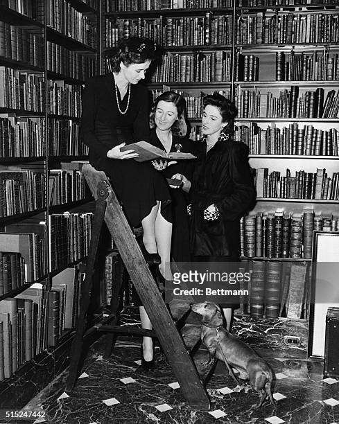 Betsy Cushing, Mary Cushing, and Barbara Cushing, selecting books in Dr. A.S.W. Rosenbach's famous library, to be auctioned off for benefit of...