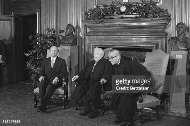 John Paul Stevens takes a seat along side Chief Justice Warren Burger and President Ford during a ceremony at the Supreme Court at which Stevens was...