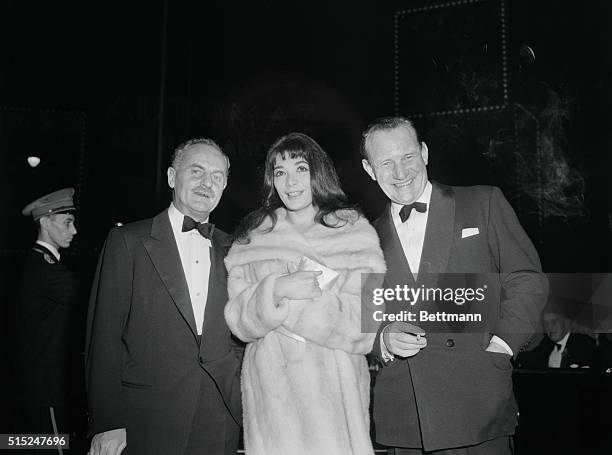 Premiere Event.Sultry actress Juliette Greco, who holds little truck with fancy hairdos, arrives at RKO Palace Theatre with producer Darryl F. Zanuck...