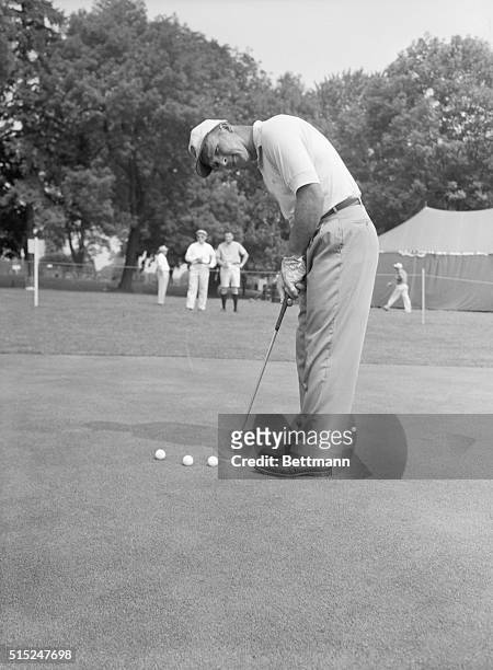 Mamaroneck, NY- Picture shows golf Pro, Arnold Palmer, practicing putting at the Winged Foot Golf Club .