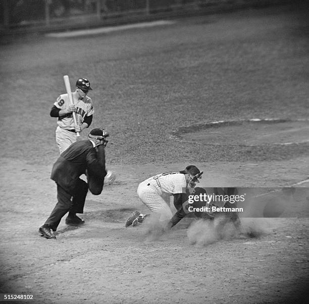 Yankees' Yogi Berra tags Cleveland Indians' Minnie Minoso as he slides into home plate in the sixth inning at Yankee Stadium, June 19, 1959.