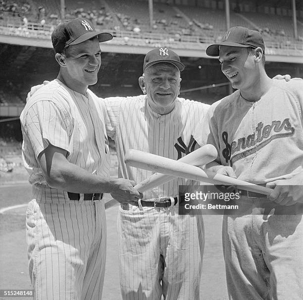 Yankees' Bill Skowron and Senators' Harmon Killebrew pose with Casey Stengel in Pittsburgh on July 5 in preparation for their positions as American...