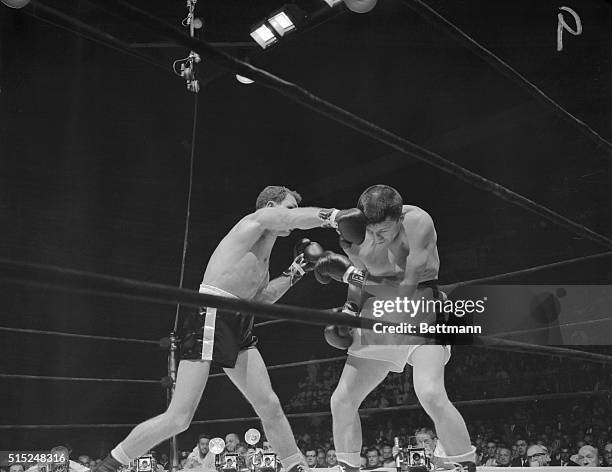 Manhattan, New York, New York: Carlos Ortiz stops Kenny Lane for junior welterweight championship. Photo shows Carlos Ortiz lands a right to Kenny...