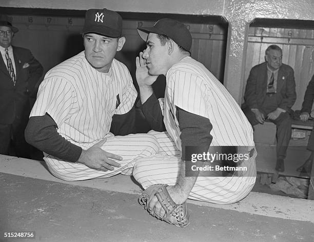 Bronx, New York: Yank's starting pitcher Allie Reynolds , and catcher Yogi Berra get together for a conference before start of first Series game....