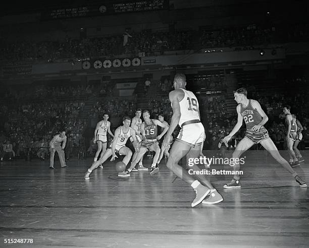 New York, New York: Knick Nicked--Ernie Vandeweghe of Knicks is fouled by Bones McKinney of Celtics while driving in for shot at basket during...