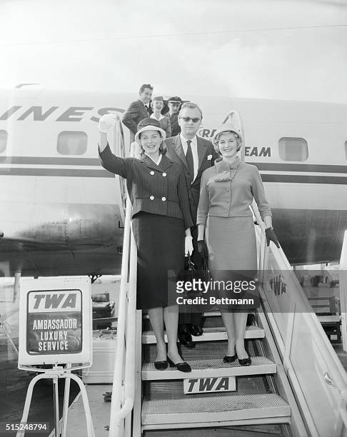 Idlewild Airport. Photo shows Ingrid, her husband, Lars Schmidt, and her daughter Lindstrom as they come down ramp of plane.