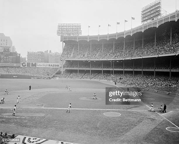 Hank Bauer triples with the bases loaded, scoring Yogi Berra, Joe DiMaggio and Johnny Mize, during the 6th inning of the 6th World Series game at...