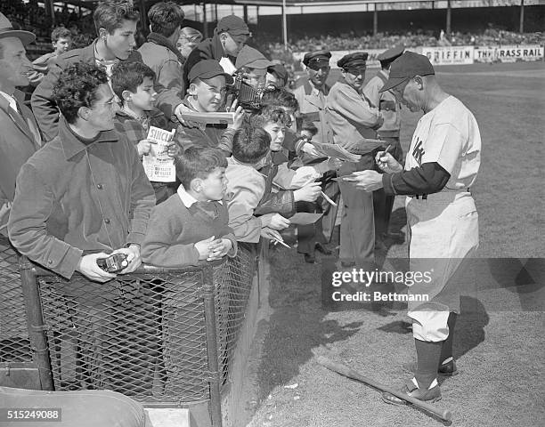 Coach Charlie Dressen of the Yankees is a very popular guy with the kids as photo shows him signing autographs for the kids at Ebbets Field.