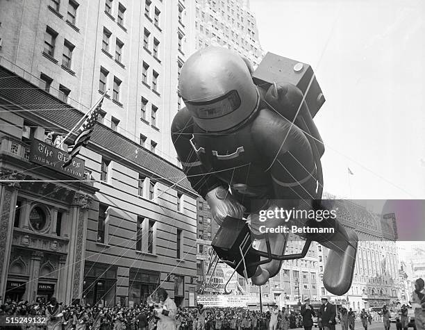 Giant spaceman balloon looms over the crowd watching the Macy's Thanksgiving Day Parade in New York City. The helium-filled balloon was one of the...
