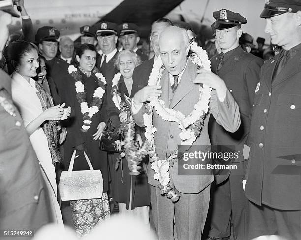 Photo shows Pandit Jawaharlal Nehru, Prime Minister of India, being decorated with garlands of flowers by the Ladies' Committee of N.Y.C., India...