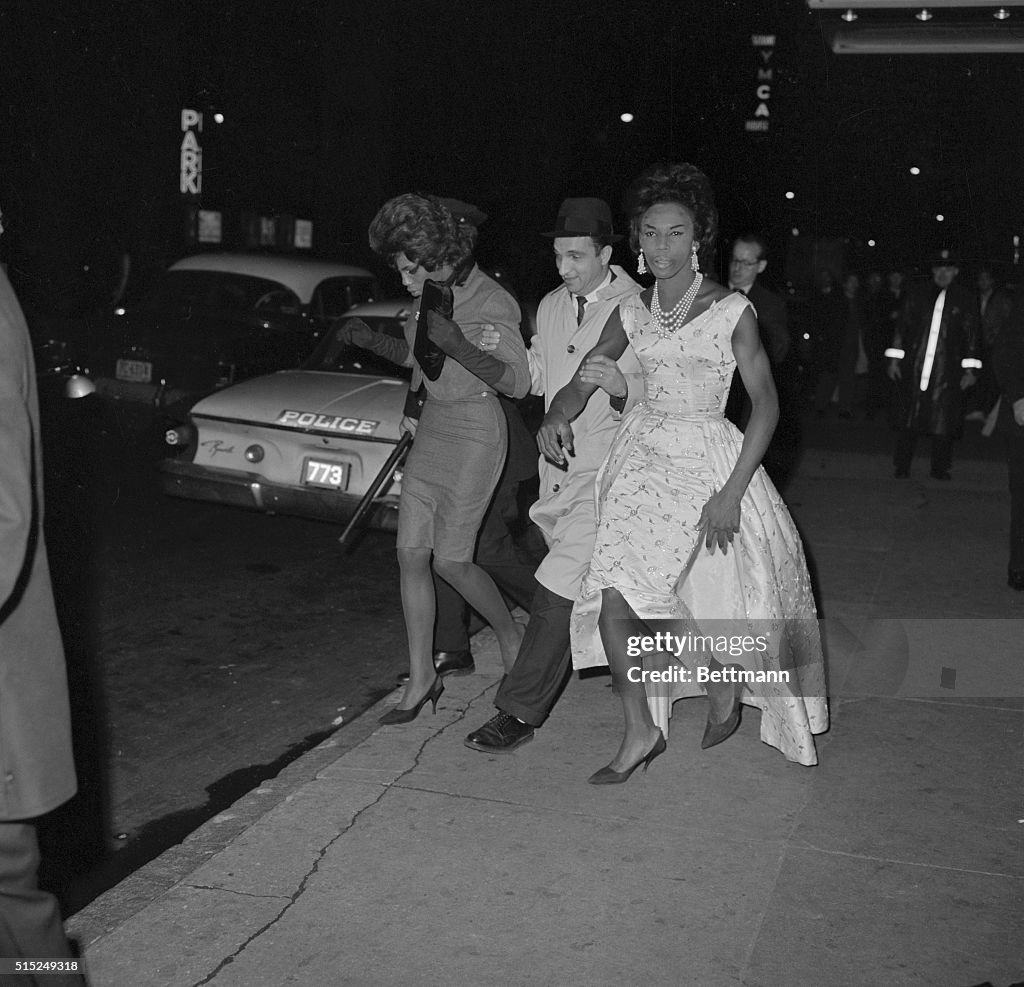 Policeman Arresting Two Men in Drag