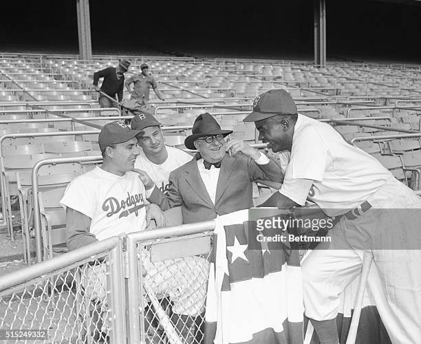 The Dodgers at Yankee Stadium are shown with left to right Gil Hodges, Gene Hermanski, Branch Rickey, and Jackie Robinson, during the World Series.