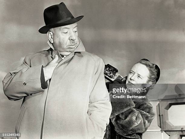 Alfred Hitchcock, famed screen director poses for a "sinister" type snapshot for his wife, Alma.