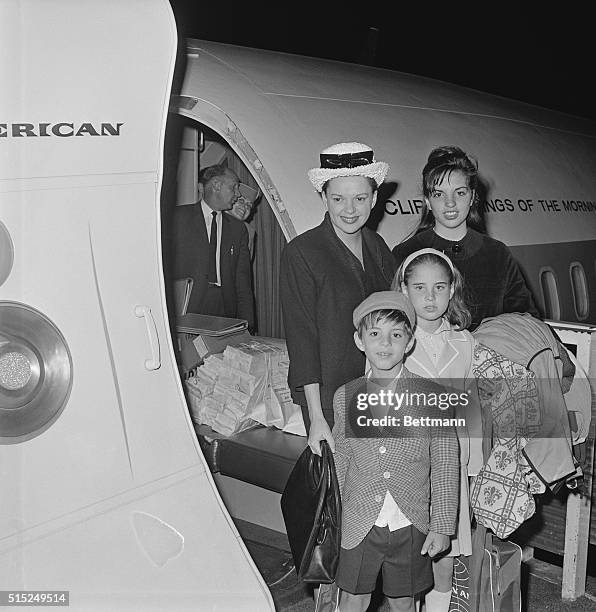 This is Judy Garland, , as she departs from Idlewild for London with her children : Joey Luft, , Lorna Luft, , and Liza Minnelli, .