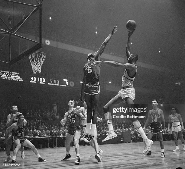 Boston vs. Philadelphia. Madison Square Garden. New York, New York: Bill Russell of Boston in on action as Wilt Chamberlain of Philadelphia misses...