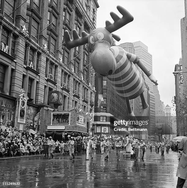 Giant Bullwinkle float looms over the crowd in the Macy's Thanksgiving Day Parade in New York City. Despite the weather, a large crowd came out to...