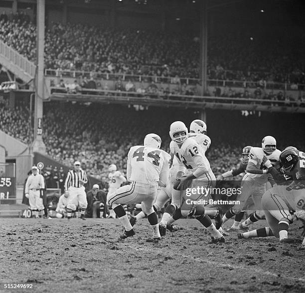 It's a fake...St. Louis quarterback Charley Johnson fakes a handoff to halfback John David Crow in this closeup of yesterday's lively grid action...