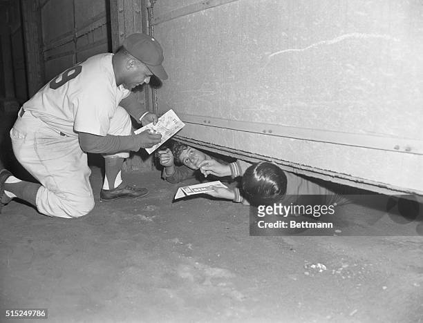 Brooklyn: OBLIGING with his autograph is Flocks' catcher Roy Campanella, who hit his 31st homer with two on in eighth inning of yesterday's thriller...