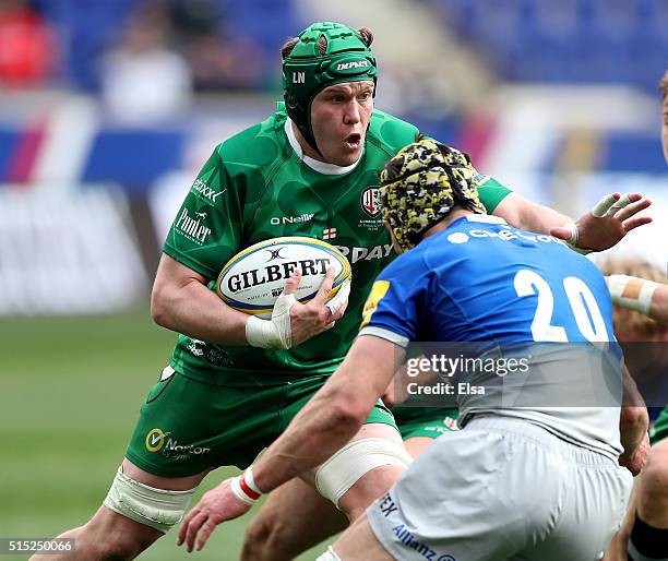Luke Narraway of the London Irish carries the ball as Kelly Brown of Saracens defends during the Aviva Premiership match on March 12, 2016 at Red...