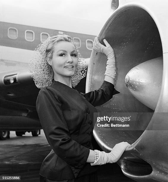 Rocketing to Filmdom. Julie Newmar, who has scored in several Broadway Hits, pauses beside jet engine intake before streaking to Hollywood via TWA....