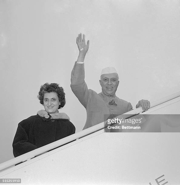 While boarding a plane at La Guardia Airport, in 1961, Prime Minister Jawaharlal Nehru of India and his daughter, Indira Gandhi, wave as they leave...