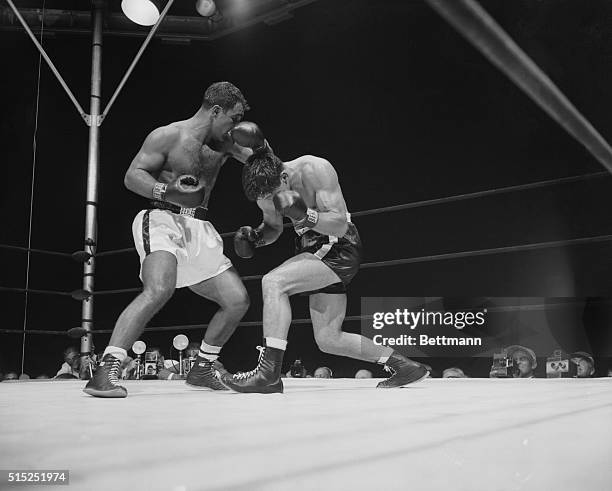 Roland LaStarza receives a blow to the head from Rocky Marciano during their match at Manhattan's Polo Grounds in 1953.