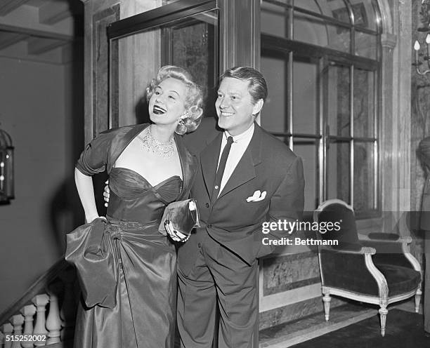 Film actress Virginia Mayo is escorted by her husband, Michael O'Shea, to the Fan Ball held in aid of the Children's Memorial Cancer Fund, at the...