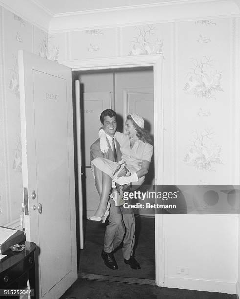 New York City: Tony Curtis and his wife Janet Leigh in their honeymoon suite at the Waldorf. They are both movie artist.