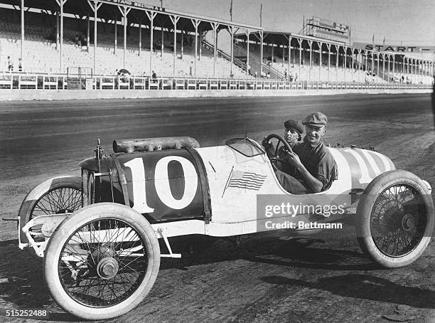Picture shows "Rick" at the wheel of a 1914 Duesemberg at the Indianapolis Speedway.