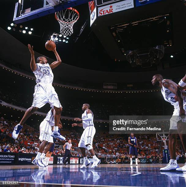 Grant Hill the Orlando Magic rebounds against the Dallas Mavericks during the game at the TD Waterhouse Center on October 17, 2004 in Orlando,...