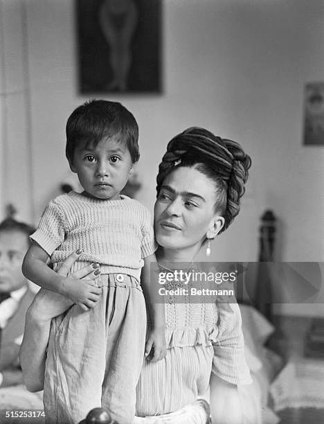 Frida Kahlo, , Mexican painter and wife of Diego Rivera is shown here with child.