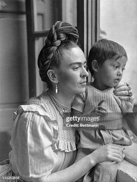 Frida Kahlo, , Mexican painter and wife of Diego Rivera is shown here with child.