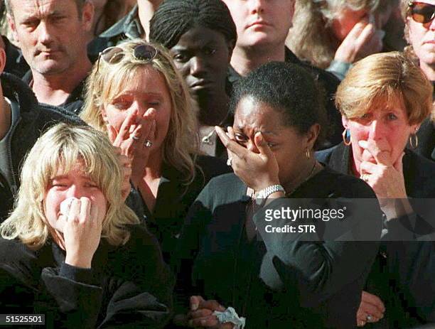 Spectators weep in the crowd along London's Whitehall 06 September during funeral ceremonies for Diana, Princess of Wales.