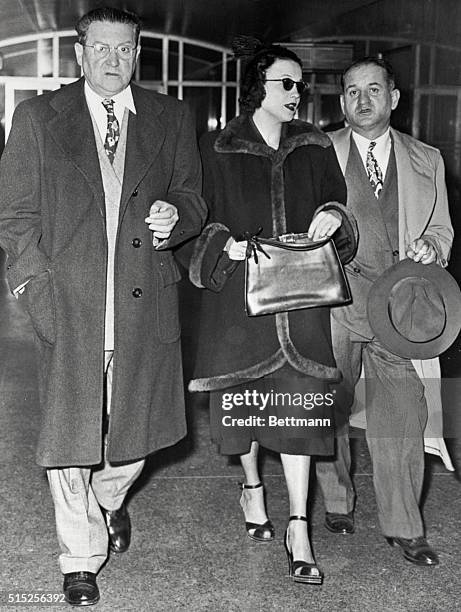 Shown leaving the criminal courts today are left to right - "Trigger Mike" Coppola; his wife, Doris, said to be expecting a baby in March , and her...