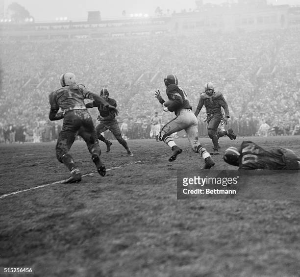 Aramis Dandoy of Southern California, carries the ball on his first offensive play of the Rose Bowl game after taking Hubert Bobo's punt on his own...