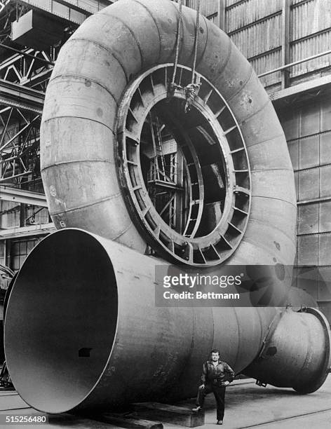 Mere man seems small in contrast to this 35-foot high, 66-ton spiral casing which will house one of two 73,000 horsepower water turbines being...