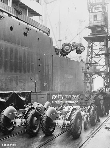 Some of the 200 Ferguson tractors being loaded aboard an American freighter at the Royal Victoria Docks in London.