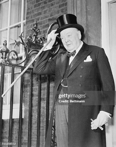On Final Palace Trip. London: With a tip of his hat, 80-year-old Sir Winston Churchill greets the crowds in front of his official residence at number...