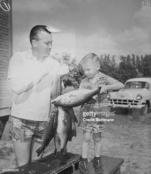 Catching Some Last Minute Fun. Vero Beach, Florida: Dodger outfielder Duke Snider proudly shows his 26 pound catch of bass to his young son, Kevin at...