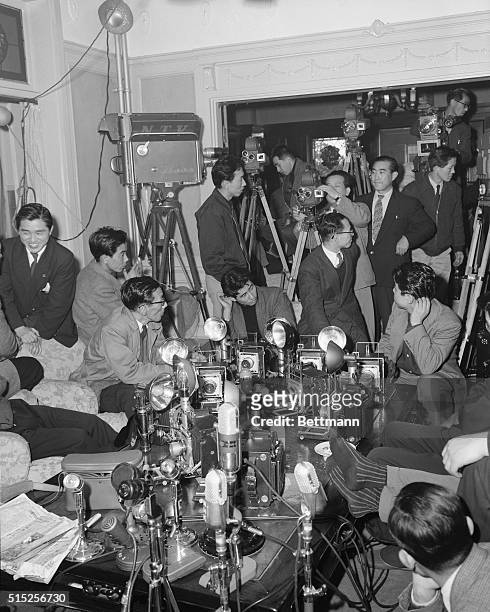 Journalists, television and newsreel cameramen are shown waiting for Prime Minister Ichiro Hatoyama at his private residence in Tokyo, after his...
