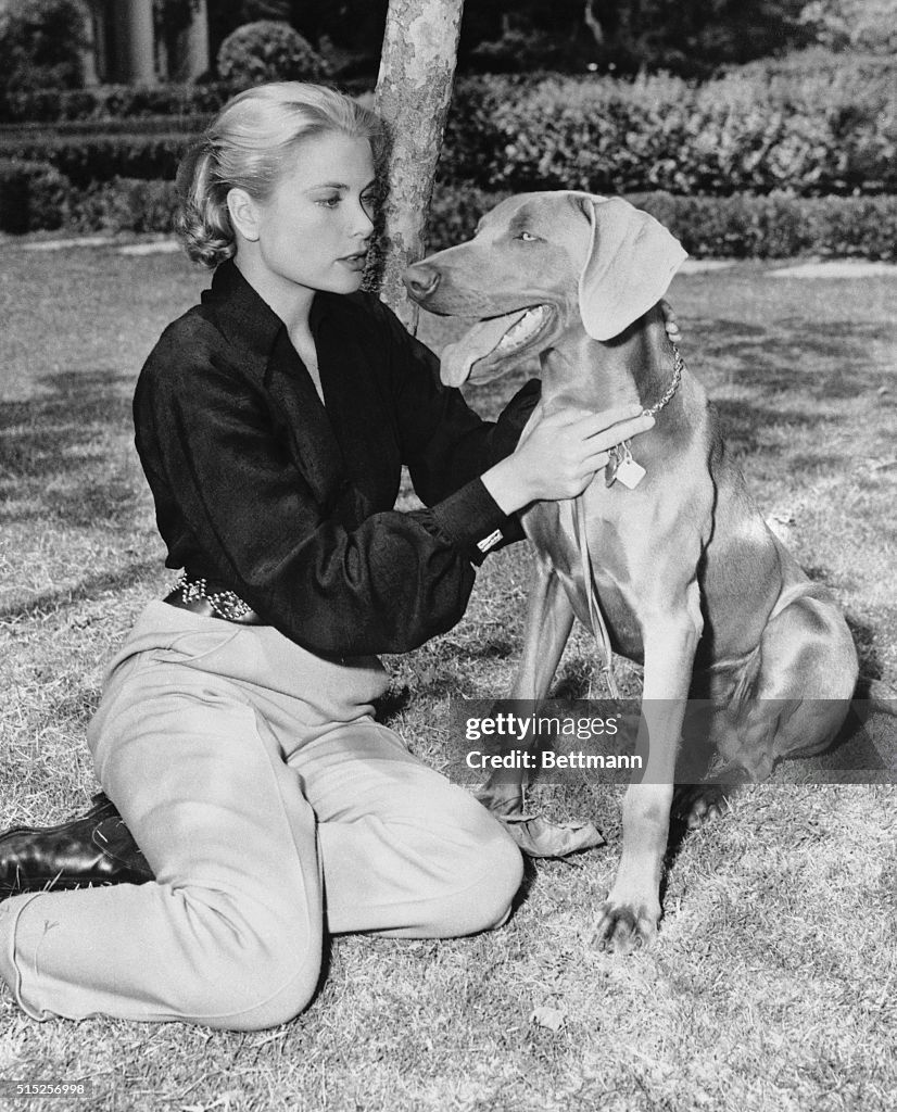 Grace Kelly Petting a Dog
