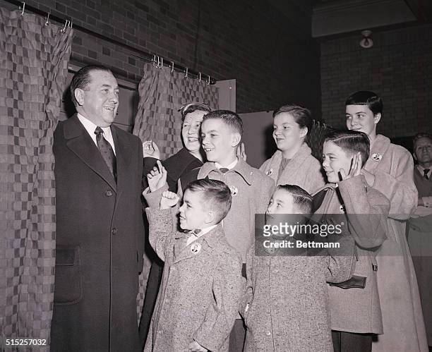 Ricard J. Daley, Democratic Candidate for Mayor of Chicago, prepares to cast his vote in the primary election as his family gathers around to wish...