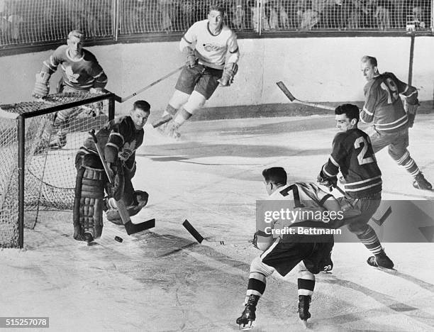 Detroit: Winging It In. Ted Lindsay, , captain of the Detroit Red Wings, drives the puck past Harry Lumley, Toronto Maple Leafs goalie, to score in...