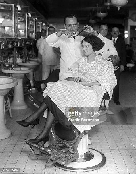Miss Muriel Redd of Chicago, appearing in show "Tickle Me", having her hair bobbed by Lewis Morgan, manager, at the Hotel McAlpin barber shop.
